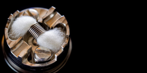 close up, macro shot of single micro coil with japanese organic cotton wick in high end rebuildable...