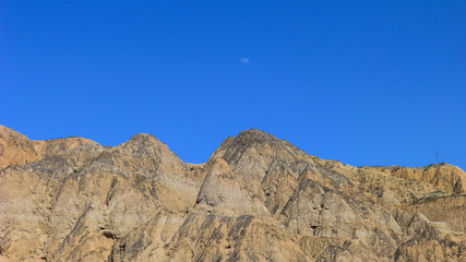 Fototapeta na wymiar Rugged and Bare Mountains under the Blue Sky