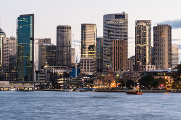 Stunning view of the sunset over the Sydney financial district skyline and the Circular Quay harbor...