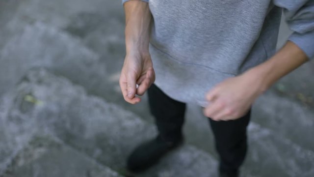 Young man secretly taking narcotic pills, addicted to painkiller drugs, abuse