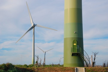 Wind turbines at sunset at a beach in Changhua, Taiwan