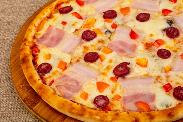 Pizza with ham and sausages