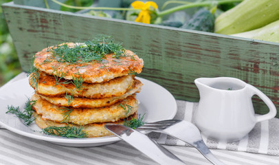 Delicious pancakes from courgettes and fresh vegetables with sour cream and dill