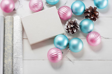 Pink and blue Christmas balls with gift box and wrapping paper