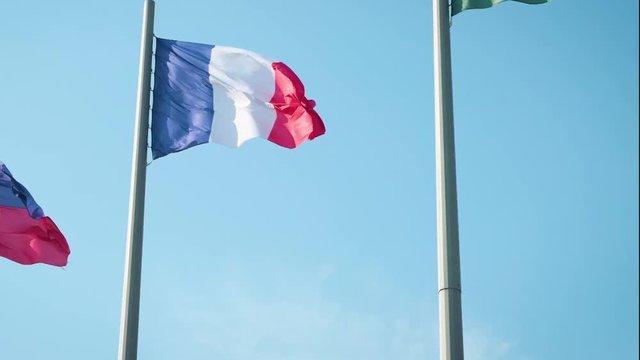 Slow motion of French flag fabric waving in front of blue sky 1920X1080 FullHD footage - Tricolor flag of France slow-mo flowing by the day 1080p HD video.