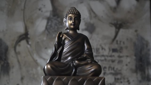 Small buddha statue with slight smoke around.