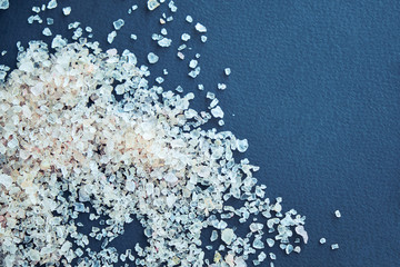 Himalayan pink salt in crystals above a gray stone