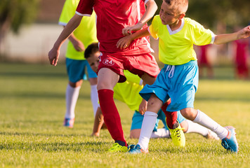 Obraz premium Young children players football match on soccer field