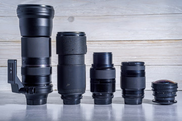 photographic lens on a white wooden background