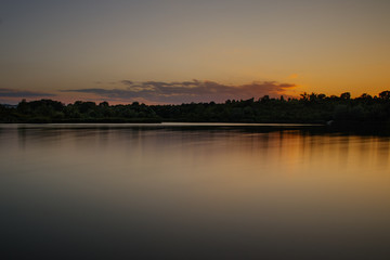 sunset over a scenic lake with orange light