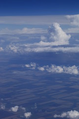 Fototapeta na wymiar Небо. Облака. Земля с высоты. Виды из окна самолёта. Полёт. Поля облаков.