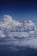 Fototapeta na wymiar Небо. Облака. Земля с высоты. Виды из окна самолёта. Полёт. Поля облаков.