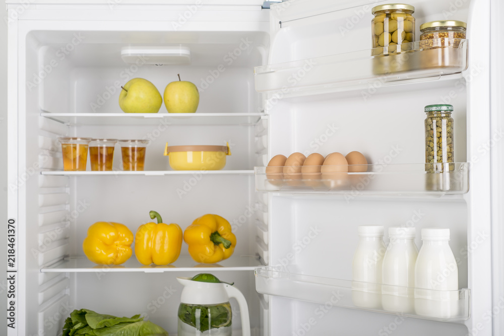 Wall mural open fridge full of fresh fruits and vegetables