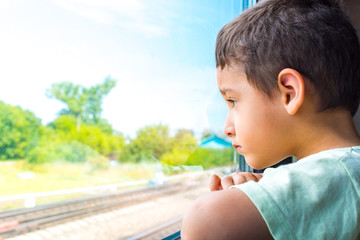 boy rides the train and looks out the window