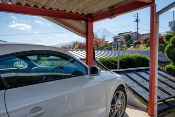 White modern sport car parked inside open garage and view Fuji-san mountain