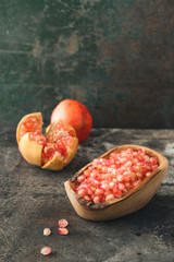 Ripe pomegranates. On rustic background