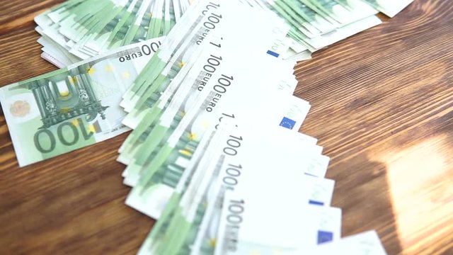 Money are falling on the table. Dropping on table lot of Euro paper money.