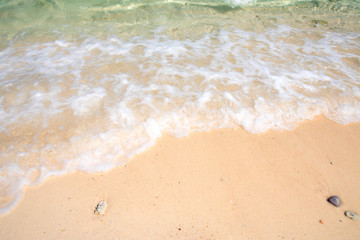 Fototapeta na wymiar Sea waves on white sand beach, tropical blue ocean, bubble waves at Koh Lipe island, Satoon Province in Thailand, beautiful landscape view of sea waves.