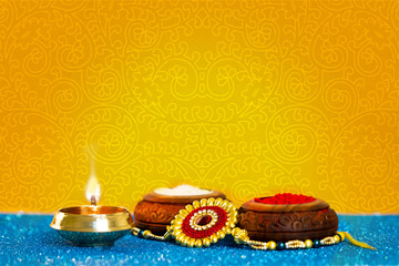 Raksha Bandhan rakhi with flowers diya gift and sweets