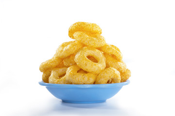 Corn rings snacks in a bowl isolated on a white background