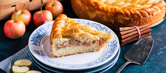 Apple pie on a blue background, sweet pastries, home cooking, slice, banner