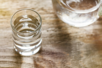 glass full of fresh crystal clear water on vintage wooden table