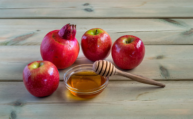 Apple and honey on wood deck, traditional food of jewish New Year - Rosh Hashana.