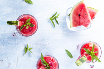 Top view of watermelon drink in glasses with slices of watermelon and mint leaves