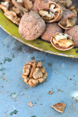 Walnut kernels and whole walnuts on rustic old table