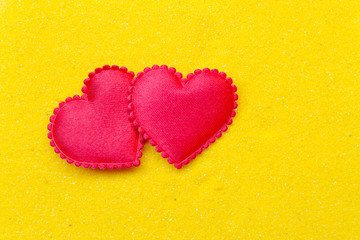 Two red heart on yellow sand background. Happy Valentines Day Concept.