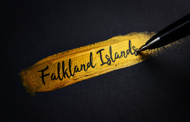 Falkland Islands Handwriting Text on Golden Paint Brush Stroke