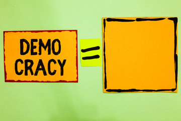 Writing note showing Demo Cracy. Business photo showcasing freedom of the people to express their...