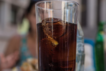 cola drink with ice and a slice with lemon