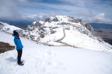 Tourist woman standing and enjoy view of beautiful snow mountains name 