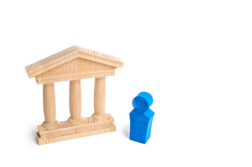 A blue figure of a person stands near a public building. The candidate makes a speech. Elections to the presidents or parliament. Speech to the electorate. Political debate, struggle.