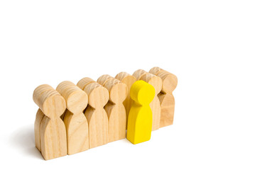 The chosen person among others. A human figure of green color stands out from the crowd. Wooden...