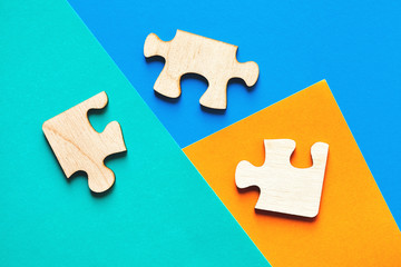jigsaw wooden pieces of puzzle on modern minimalistic colorful background