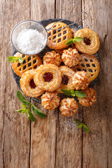 Sweet biscuit cookies set with mint and powdered sugar close-up. Vertical top view