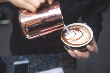 Coffee Latte Barista making pattern in a cup of coffee shop