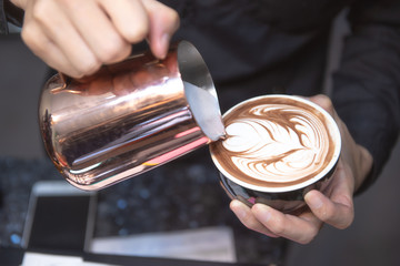 Coffee Latte Barista making pattern in a cup of coffee shop