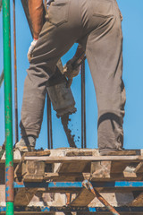 the construction, cement pouring with machine into the frame of the house, worker, man