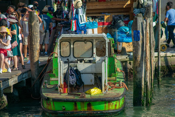 Fototapeta na wymiar Industrial boat docked in Venice Italy near by the Rialto Bridge 