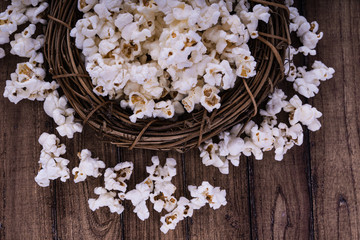 Fresh cooked Salty popcorn on wooden background