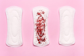 Women's hygiene products on a pink background. Concept of critical days, menstrual cycle,