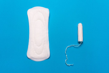 Women's hygiene products, pad, tampon on a blue background. Concept  menstruation