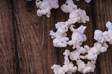 Fresh cooked Salty popcorn on wooden background