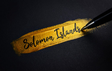 Solomon Islands Handwriting Text on Golden Paint Brush Stroke