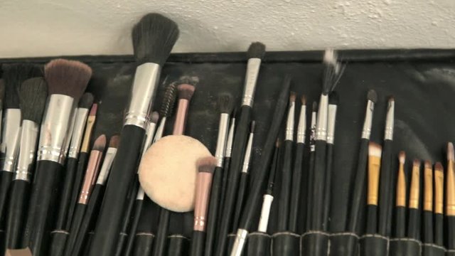 Make up kit over a white table.