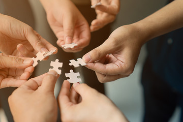 hands with jigsaw join together as team