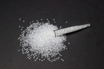 Plastic in granules. Polymer pellets. Isolated on a black background.